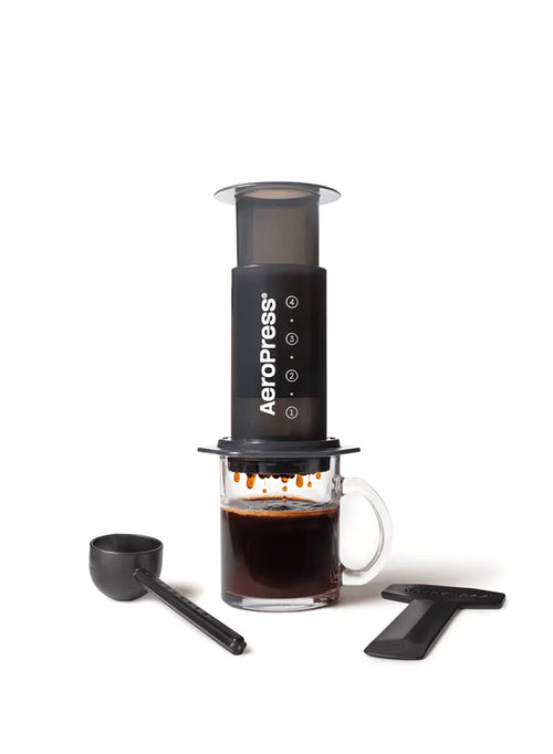 Aeropress coffee maker with a glass of brewed coffee